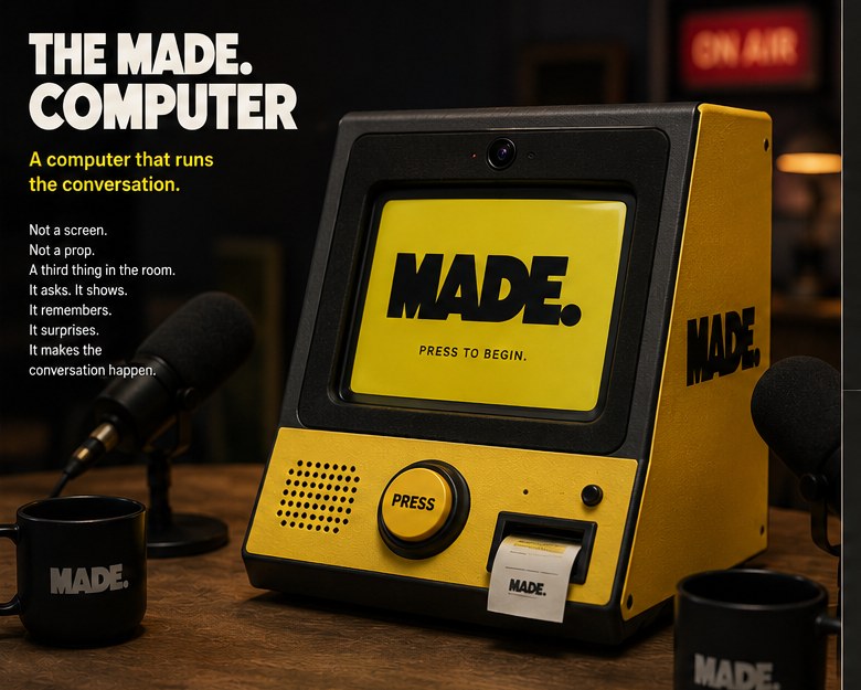 THE MADE. COMPUTER — a retro yellow and black device with a screen reading MADE. PRESS TO BEGIN, sitting on a studio table next to a microphone and a MADE. branded mug.